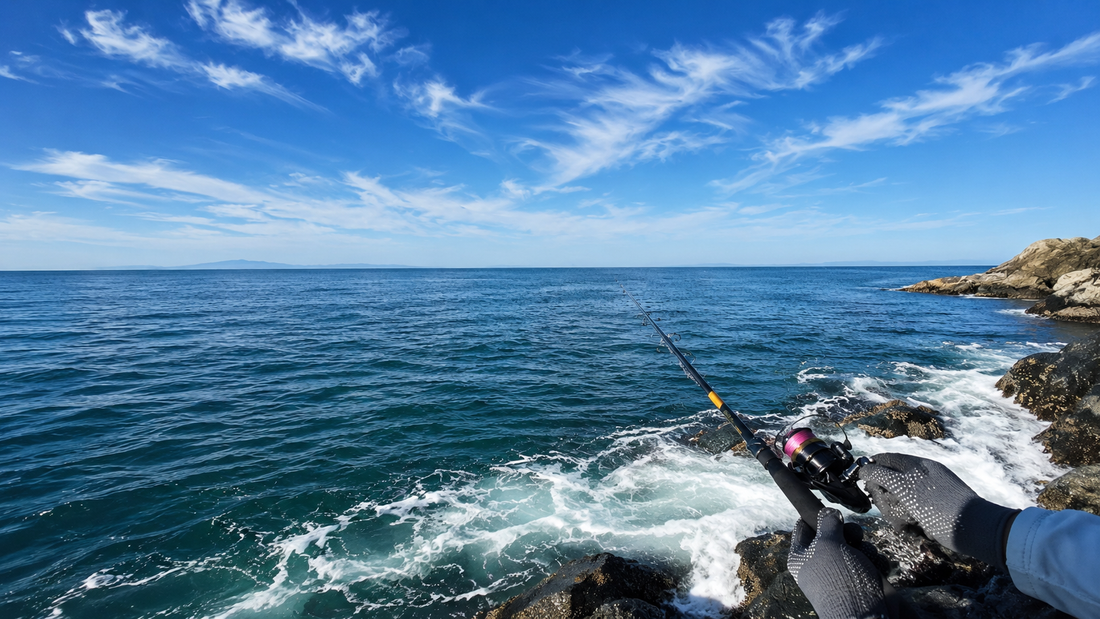 Angler casting a jig for salmon from a rocky shoreline